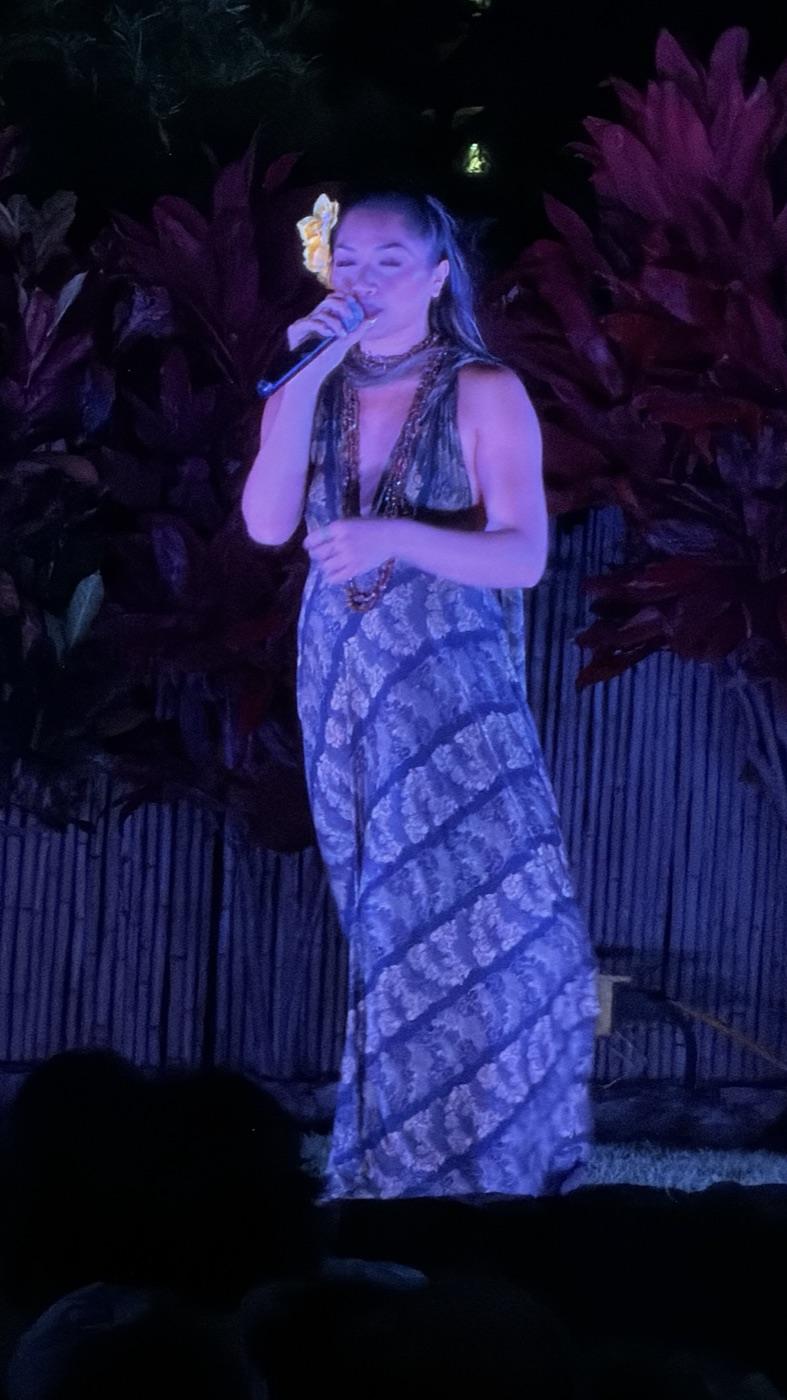 Vocalist performing under blue stage light at a private Oahu event